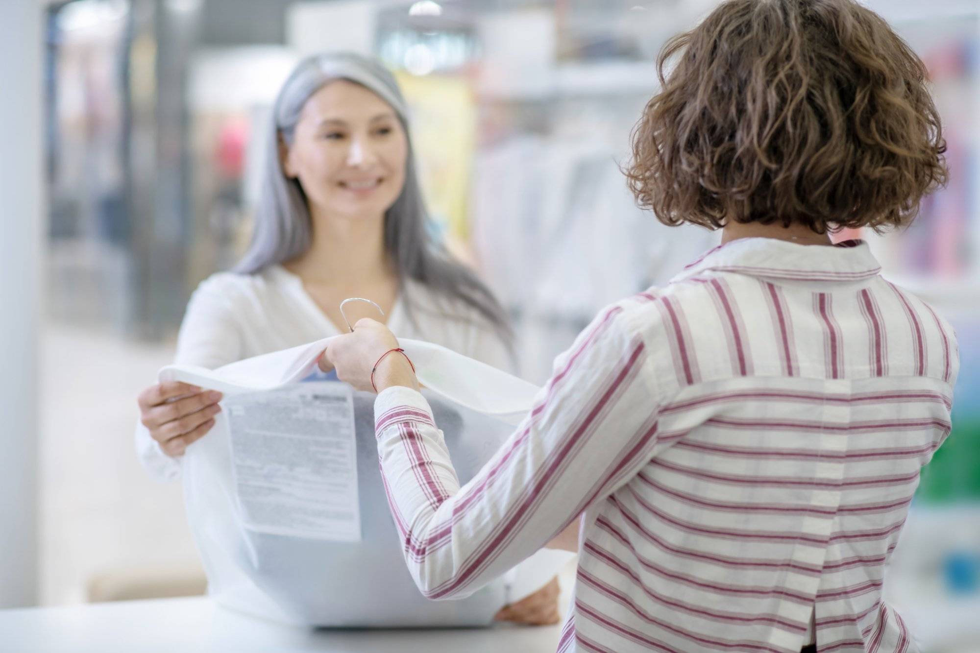 Woman with back to camera giving order to customer