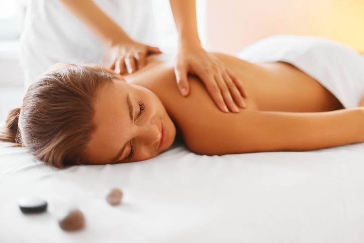 Spa Woman. Female Enjoying Massage in Spa Centre.